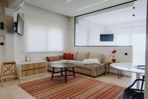 a living room with a couch and a table at Lighthouse apartments in Alexandroupoli