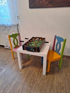 a table with a chess set on it with two chairs at Ferienwohnung Koller in Lam