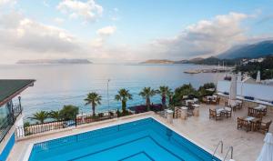 a swimming pool with a view of the water at Aqua Princess Hotel in Kaş