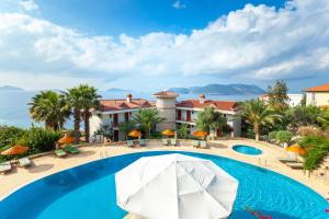 an image of a resort swimming pool with an umbrella at Aquarius Hotel in Kas