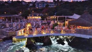 a bridge over a river with a group of people at Aquarius Hotel in Kaş