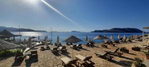 a group of chairs and umbrellas on a beach at Aquarius Hotel in Kaş