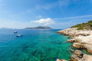 a view of the ocean with boats in the water at Aquarius Hotel in Kaş