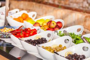 a bunch of bowls of fruits and vegetables on a table at Aquarius Hotel in Kaş