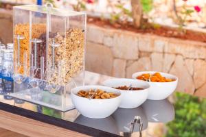 a table with bowls of food and a container of nuts at Aquarius Hotel in Kaş