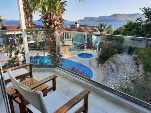 a balcony with a view of a swimming pool at Aquarius Hotel in Kaş