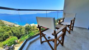 two chairs on a balcony with a view of the ocean at Aquarius Hotel in Kaş