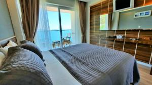 a bedroom with a bed and a television in a room at Aquarius Hotel in Kaş