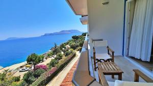 a balcony with a bench and a view of the ocean at Aquarius Hotel in Kaş