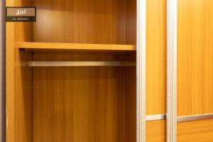 a wooden closet with wooden shelves in it at Al Manzel Sheikh Zayed in 6th Of October