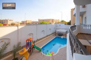 a balcony with a swimming pool on a building at Al Manzel Sheikh Zayed in 6th Of October