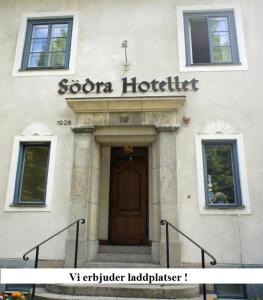 a building with a door and a sign for a hotel at Södra Hotellet in Norrköping