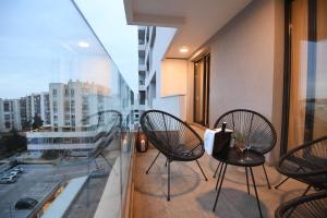 a balcony with chairs and a table on a building at K&P - Zadar Luxurious Retreat - BRAND NEW !! in Zadar