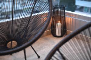 a bench sitting on a balcony with a candle at K&P - Zadar Luxurious Retreat - BRAND NEW !! in Zadar