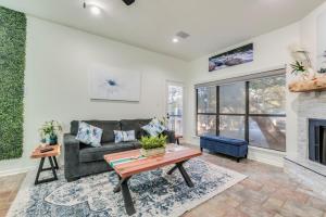 a living room with a couch and a fireplace at Comal Condo - Riverfont Complex Across from Schlitterbahn in New Braunfels