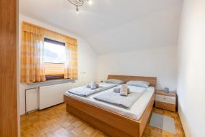 a bedroom with a bed and a window at Apartment Eli in Kranjska Gora