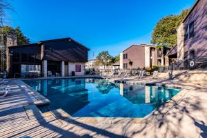 a swimming pool in front of a building at Comal Condo - Riverfont Complex Across from Schlitterbahn in New Braunfels