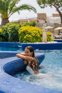 a girl is in a pool in a swimming pool at Miramare Sea Resort & Spa in Ischia