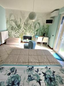 a bedroom with a bed and a couch and a table at Maryhouse - ingresso indipendente in Venegono Superiore