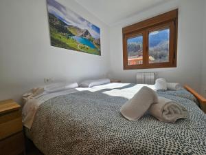 a bedroom with a large bed with a window at 24A03 Apartamento en plena naturaleza en Arenas de Cabrales in Arenas de Cabrales