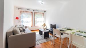 a living room with a couch and a dining room table at Fabulous Matosinhos Apartment by Unique Hosts in Senhora da Hora