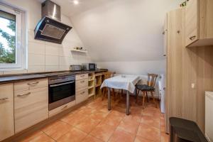 a kitchen with a table and a stove top oven at Haus Heidorn in Sittensen