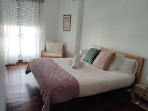 a bedroom with a large bed with pillows at El rincón de Leny in Cangas de Morrazo