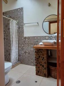 ein Badezimmer mit einem WC, einem Waschbecken und einem Spiegel in der Unterkunft Cute House Surrounded by Nature in Yucay