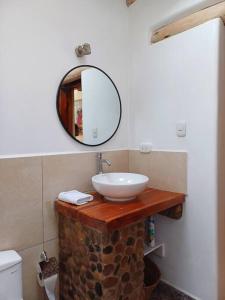 a bathroom with a sink and a mirror at Cute House Surrounded by Nature in Yucay