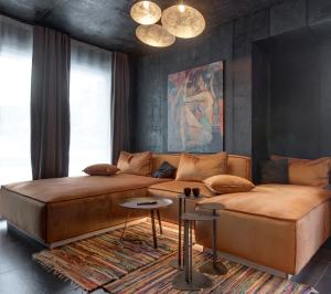 a living room with a large bed and a couch at Amuse Bouche by Skabrin in Bansko