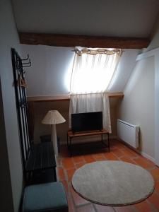 a living room with a couch and a window at Ode au Bonheur St Georges sur Cher in Saint-Georges-sur-Cher