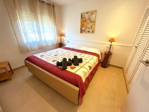a bedroom with a bed in a room with a window at Charming apartment in La Fosca Beach in Palamós