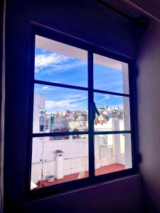 an open window with a view of a city at Socco Hostel in Tangier