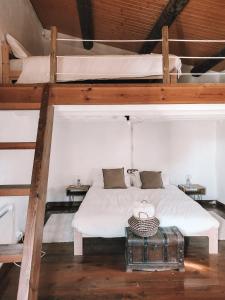 a bed in a room with two bunk beds at Casa Om in Dosríus