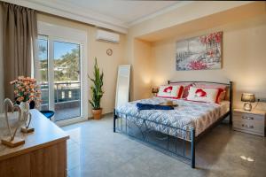 a bedroom with a bed and a large window at Katerina Apartment in Afantou