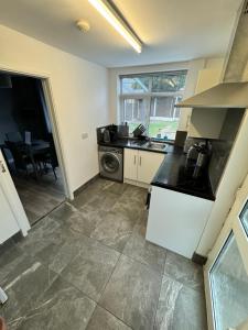a kitchen with a sink and a dishwasher at West Midlands Contractors, Nurses and Families 