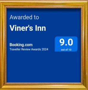 a picture frame with a sign that says awarded to winners inn at Viner's Inn in Tacloban