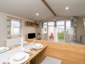 a dining room with a table with white dishes on it at The Moon in Morecambe