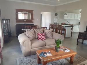 a living room with a couch and a table at Resting Place @ 89 in Bloemfontein
