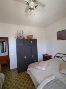 a bedroom with two beds and a ceiling fan at appartamenti del pescatore in Savelletri di Fasano