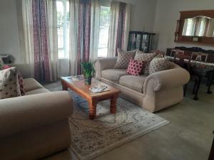 a living room with two couches and a coffee table at Resting Place @ 89 in Bloemfontein
