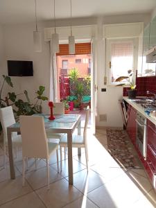 a kitchen and dining room with a table and chairs at M. BINI B&B in Bologna