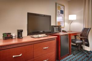 a hotel room with a television on a dresser at Fairfield Inn & Suites Boise Nampa in Nampa