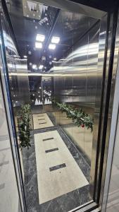 a reflection of a hallway with plants in a building at 2-х комнатная квартира Гоголя 106 in Semey