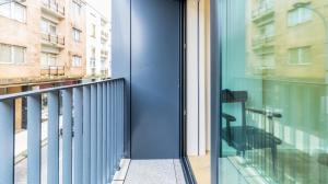 a balcony with a blue door and a window at Fantastic Cedofeita Apartment by Unique Hosts in Porto