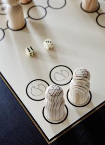 a game of dominoes and dice on a board at Hotel Landhaus Wachtelhof in Rotenburg an der Wümme