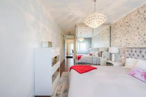 1 dormitorio con 1 cama blanca y sala de estar en Glicinias Guest House, Free garage - Aveiro, en Aveiro