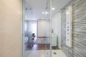a hallway with a glass door leading to a bathroom at Glicinias Guest House, Free garage - Aveiro in Aveiro +11 photos