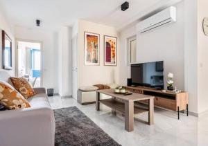 a living room with a couch and a table at Sea View Luxury Apartment Brand New in Valletta in Valletta