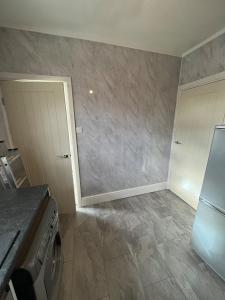 a kitchen with a washer and a door in a room at 34 Green Arbour Road in Brampton en le Morthen